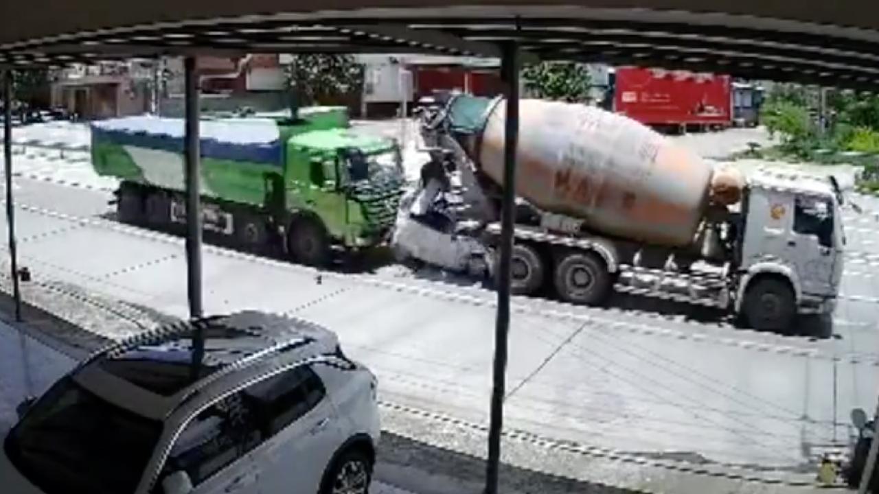Car slams into cement mixer after truck collision, driver survives CGTN