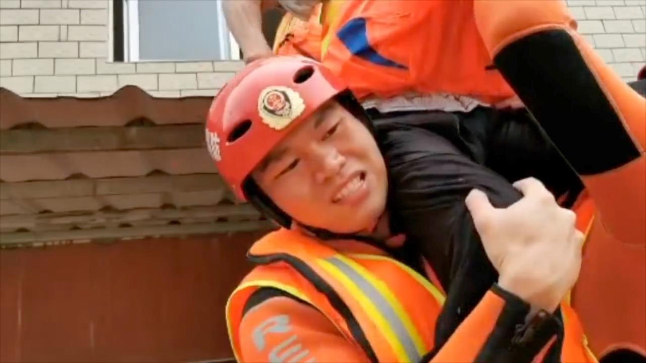 'Sit on my shoulder!' Firefighters rescue stranded old man as floods hit east China - CGTN