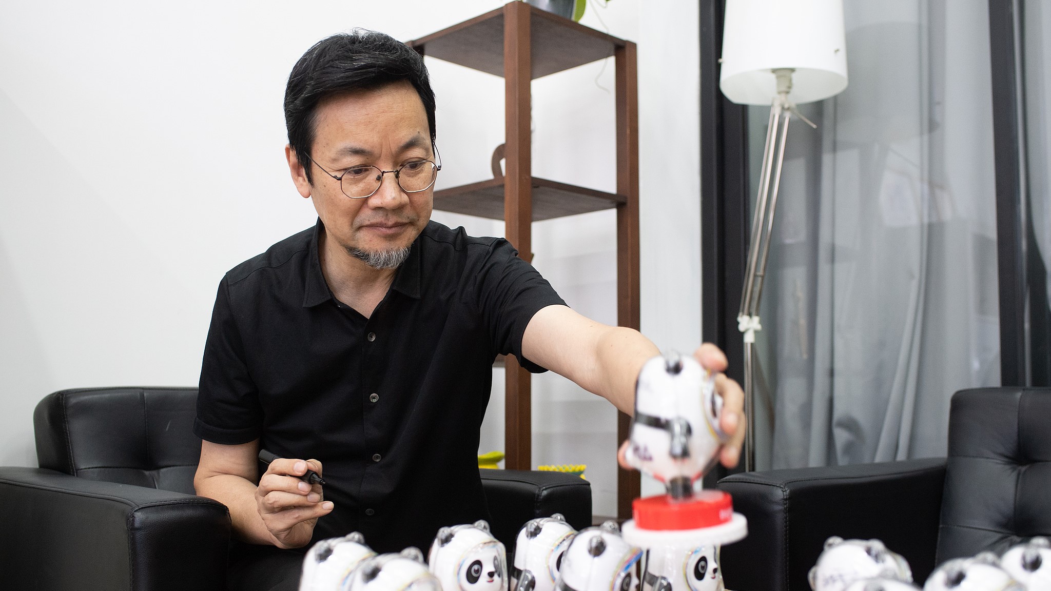 Designer of Bing Dwen Dwen recalls Bach praise and torch-bearing honor