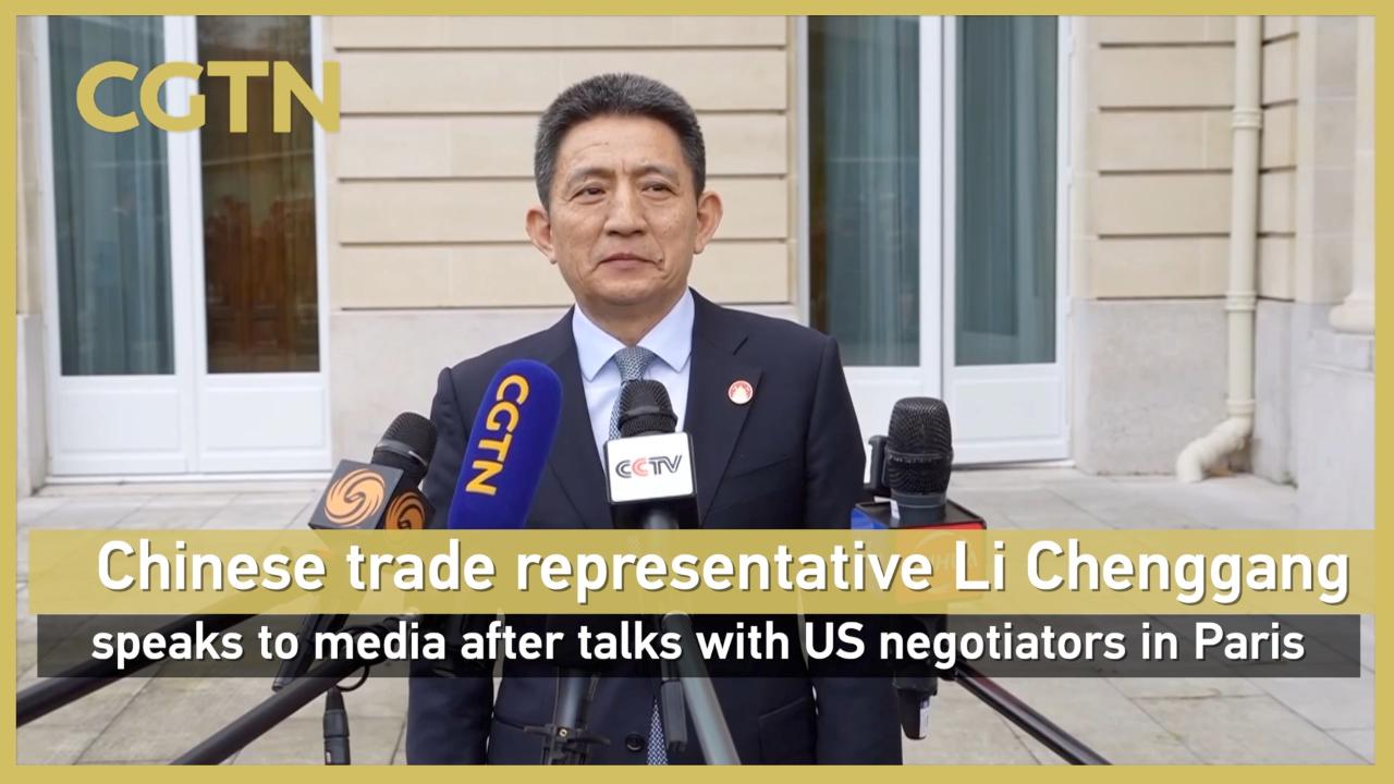 Chinese trade representative Li Chenggang speaks to media after talks with US negotiators in Paris