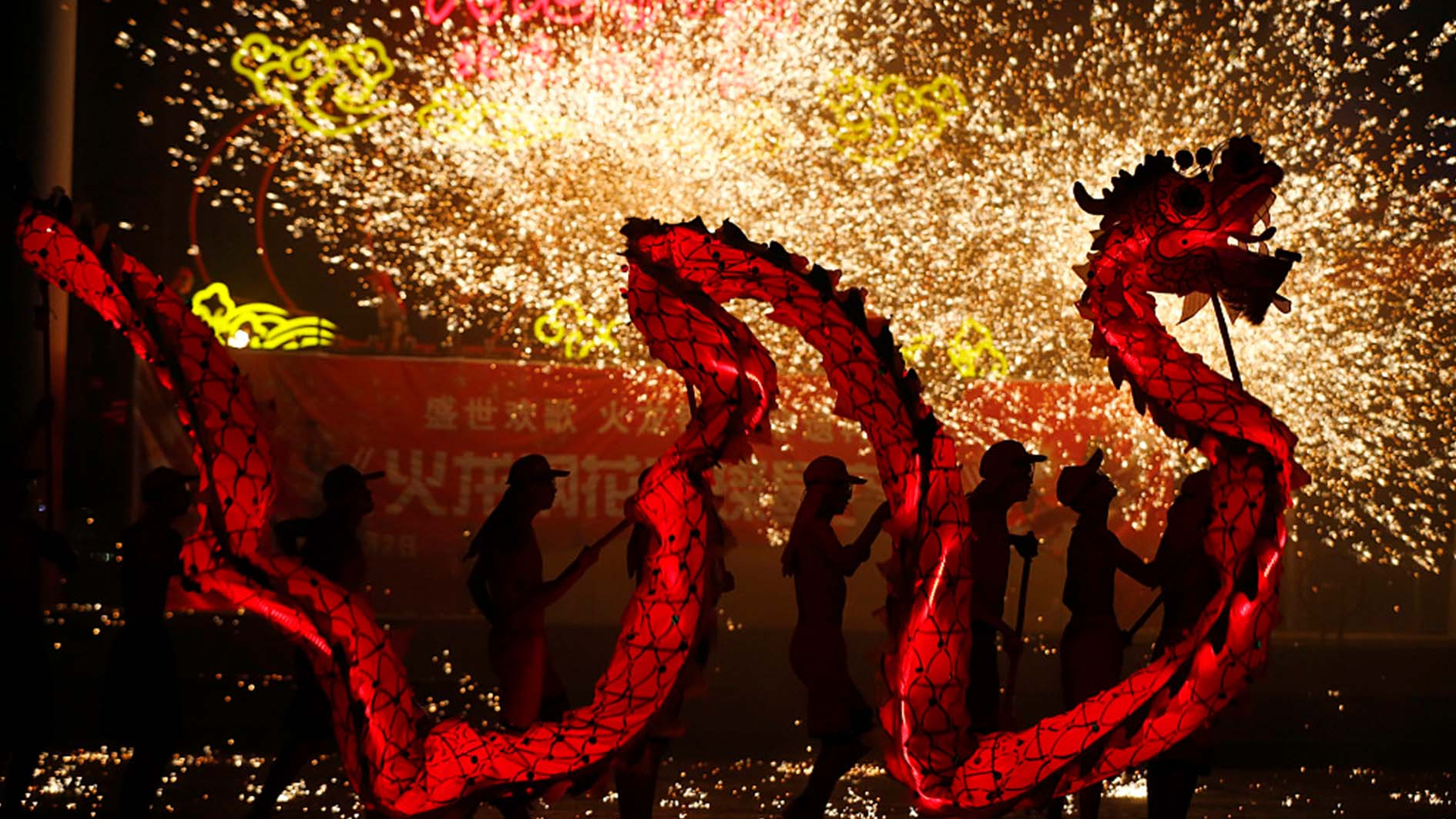 Folk artists performed a spectacular dragon dance in the midst of sparkling...
